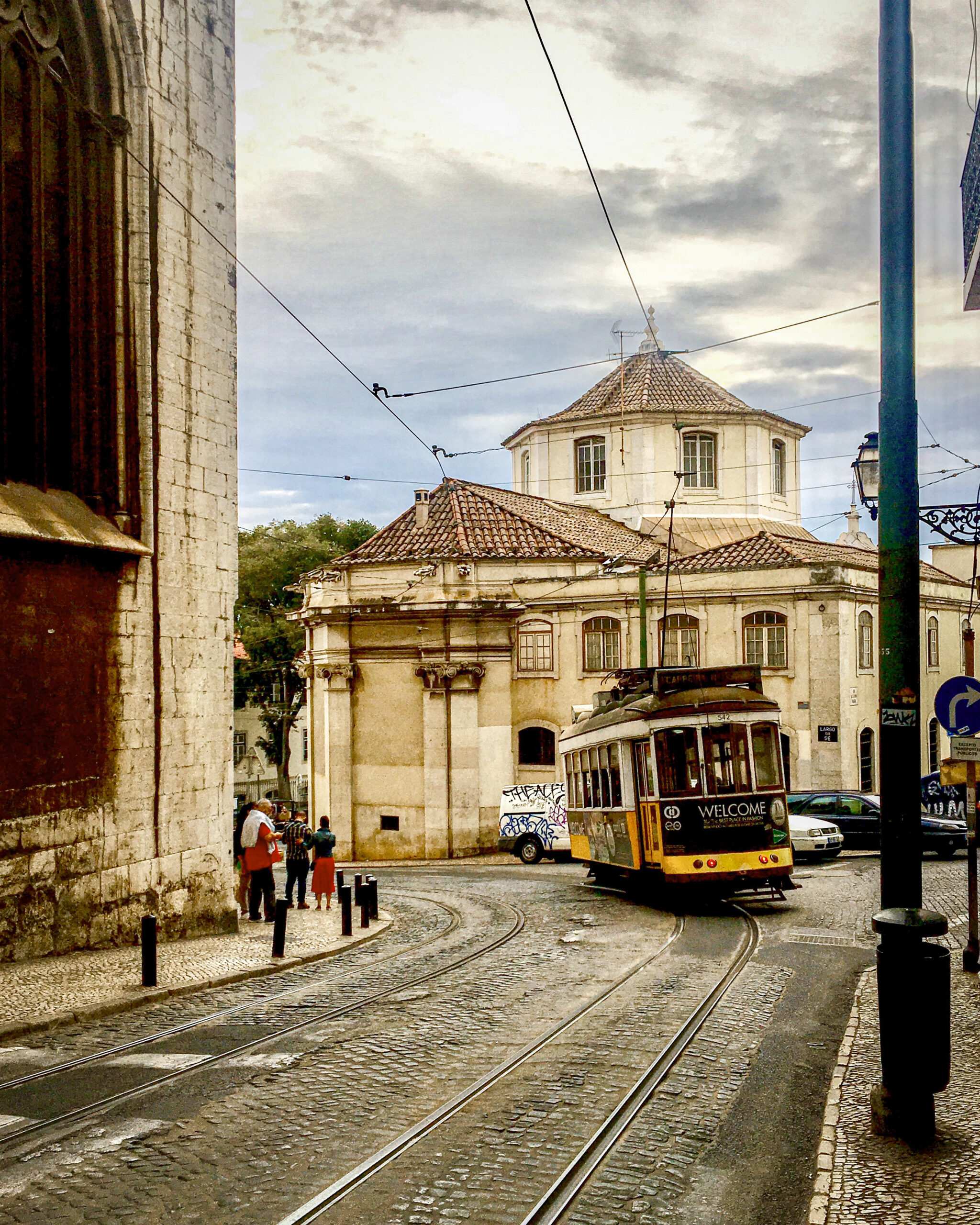 A Lisbon, Portugal streetcar moving up a hill.