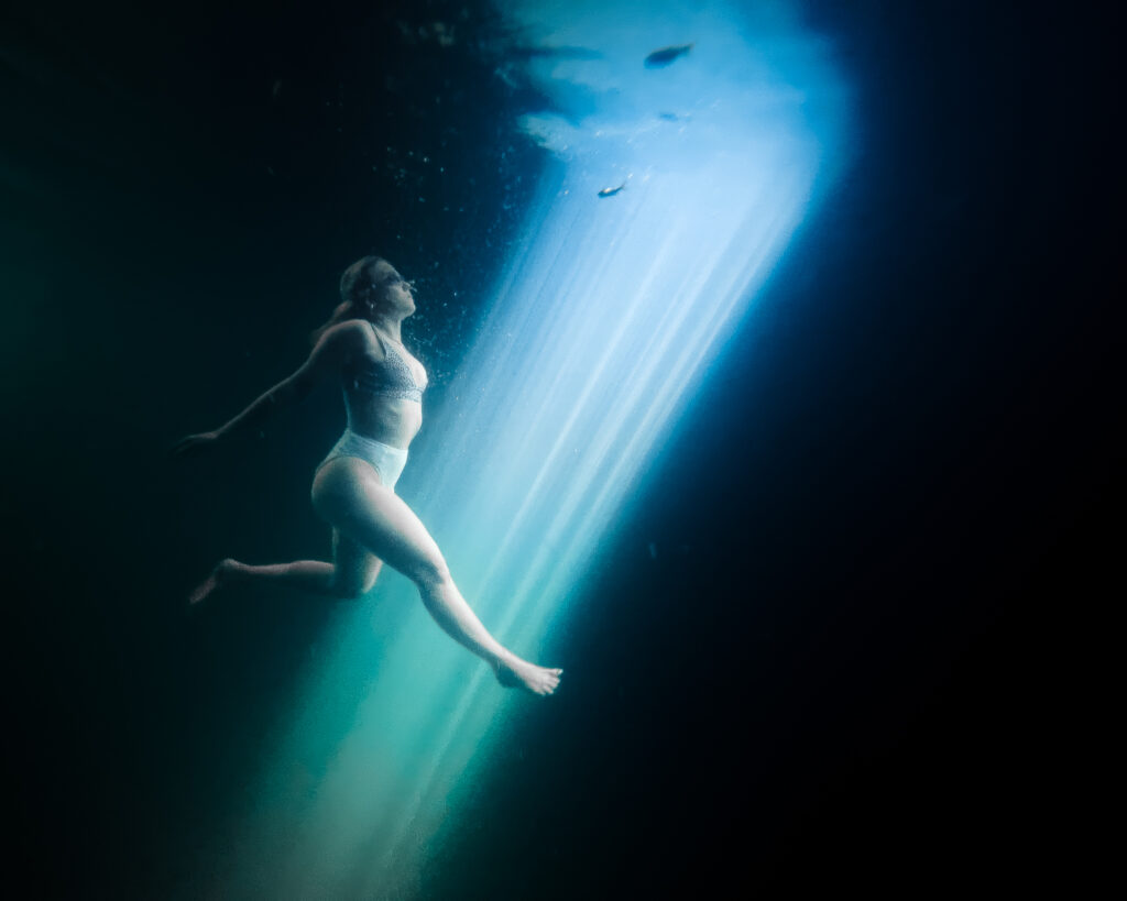 A girl swimming in a cinote